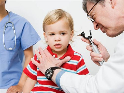 Doctor examining boys ear