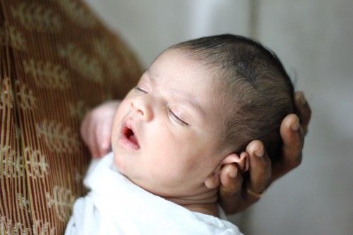Examination of the "soft spot" on infants head