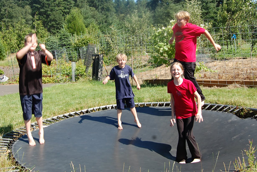 Against advice, mother and kids all on trampoline at once.