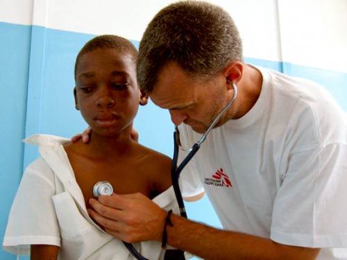 doctor examining boy with AIDS