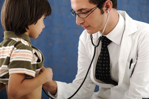 pediatric resident examining boy