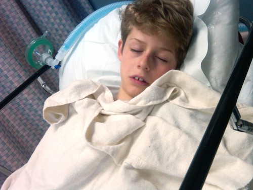 boy sick in hospital bed