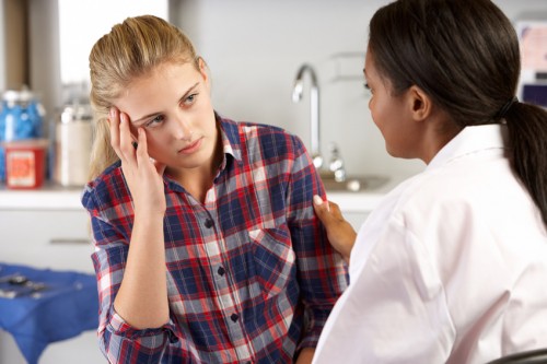 Pediatrician counseling teen about life skills