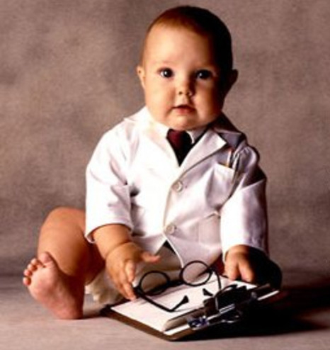 Advances in pediatric medicine - baby in white coat tie clipboard
