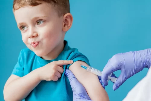 Toddler boy seemingly boored by having to receive an injection