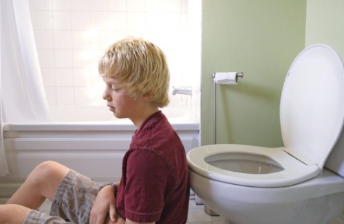 Boy in front of toilet with gastroenteritis