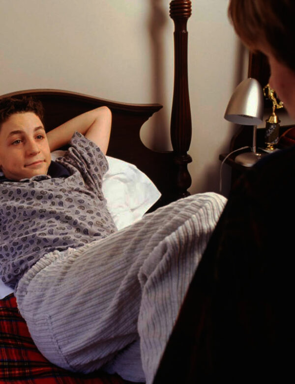 Mother talking to teen son before bedtime
